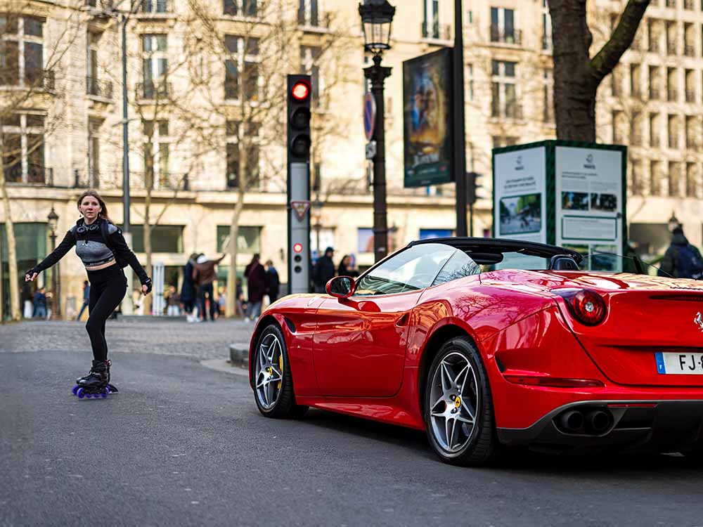 Red Ferrari near Champs-Elysées Paris with roller blader - Made You Look fine art print by Paul Holland